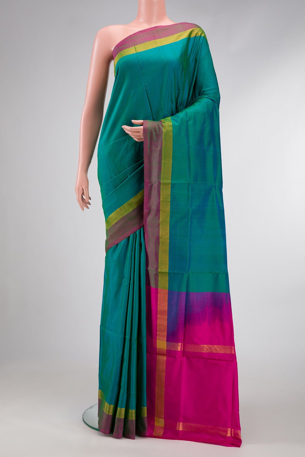 Peacock Blue Dual Tone Uppada Silk Saree with Plain Body and Zari Border.  displayed on a mannequin