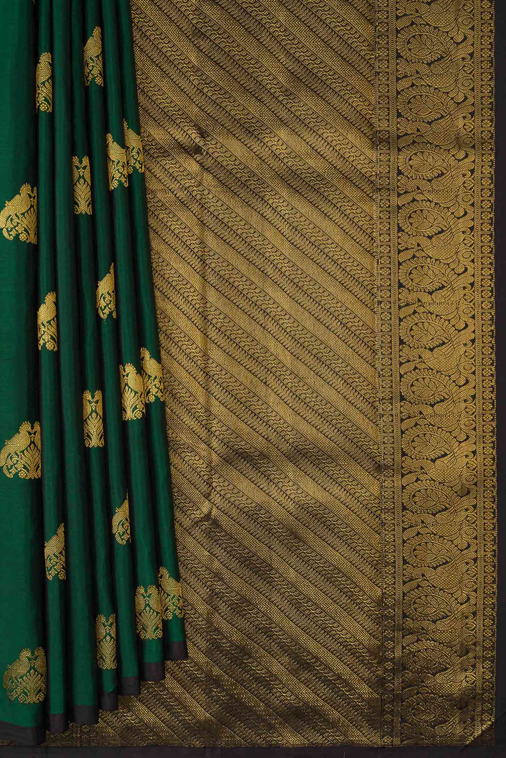 Pleats and pallu of Bottle Green Dual Tone Kanchipuram Silk Saree with Zari Butta on the body and Plain Border. 