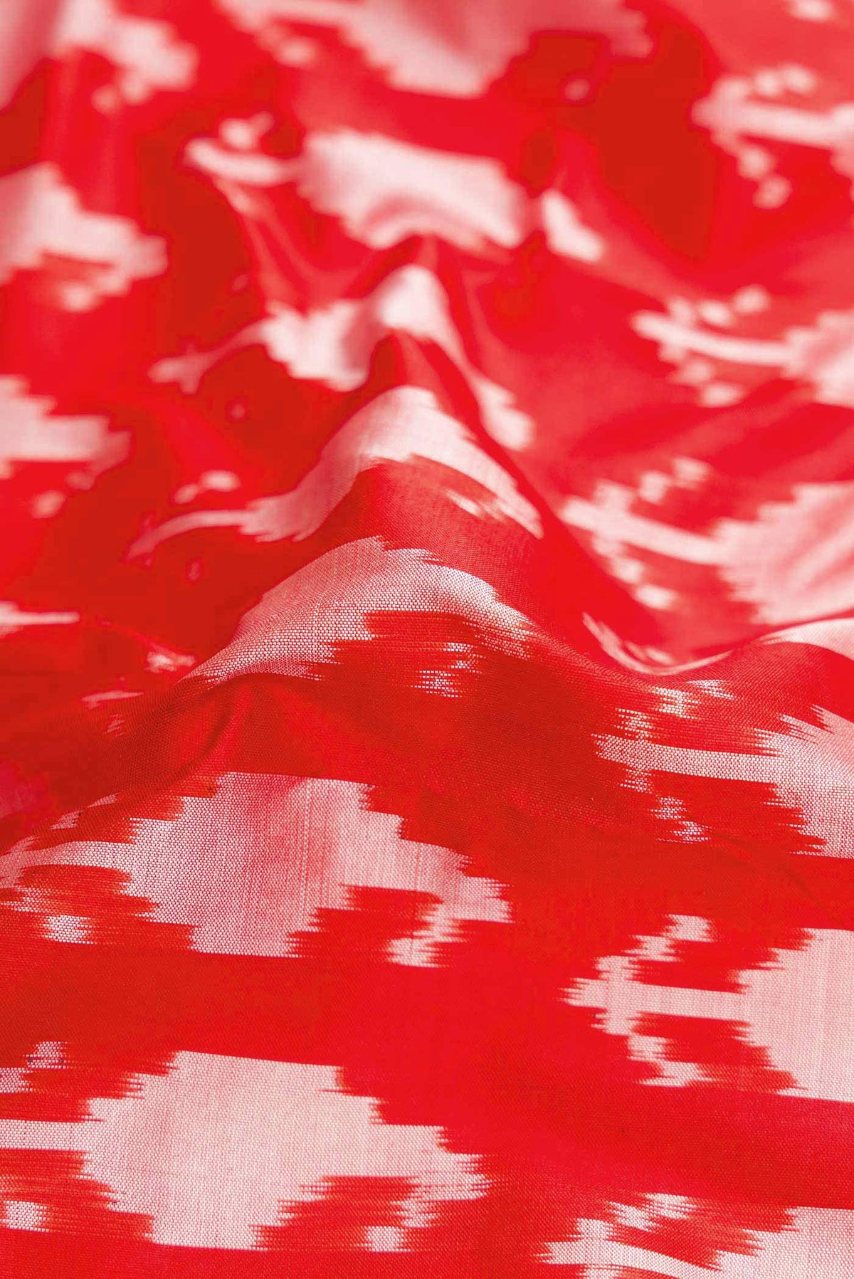 Close up of Red Pochampally Silk Saree with Pure Ikat on the body and Zari Border displaying folds