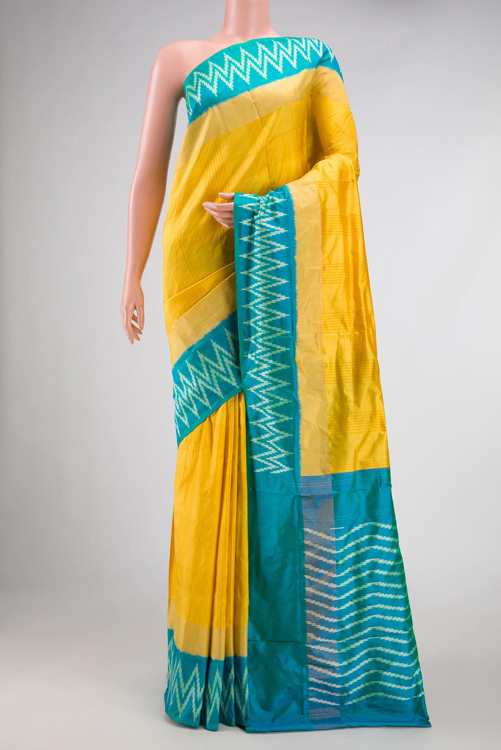 Yellow Pochampally Silk Saree with Checked design on the body and Ikat Border displayed on a mannequin
