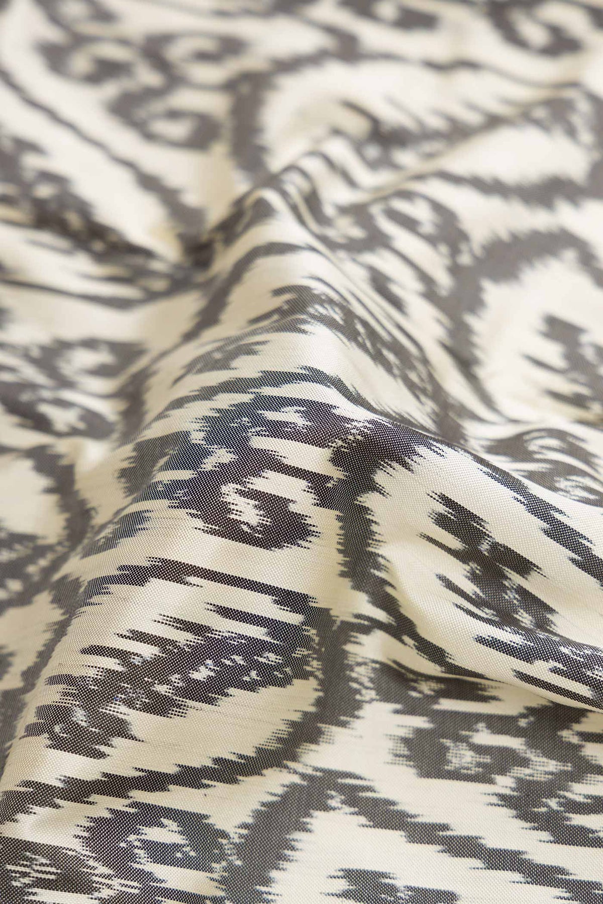 Close up of Off White Pochampally Silk Saree with Pure Ikat on the body and Plain Border displaying folds