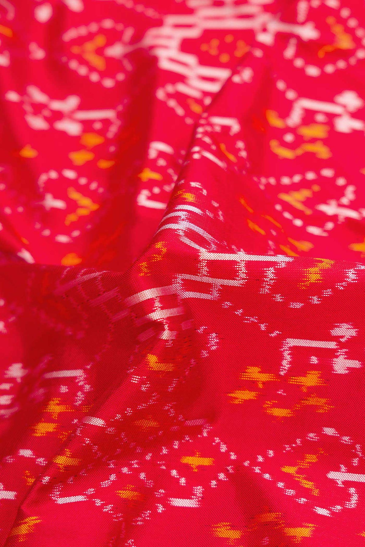 Close up of Red Pochampally Silk Saree with Pure Ikat on the body and Zari Border displaying folds