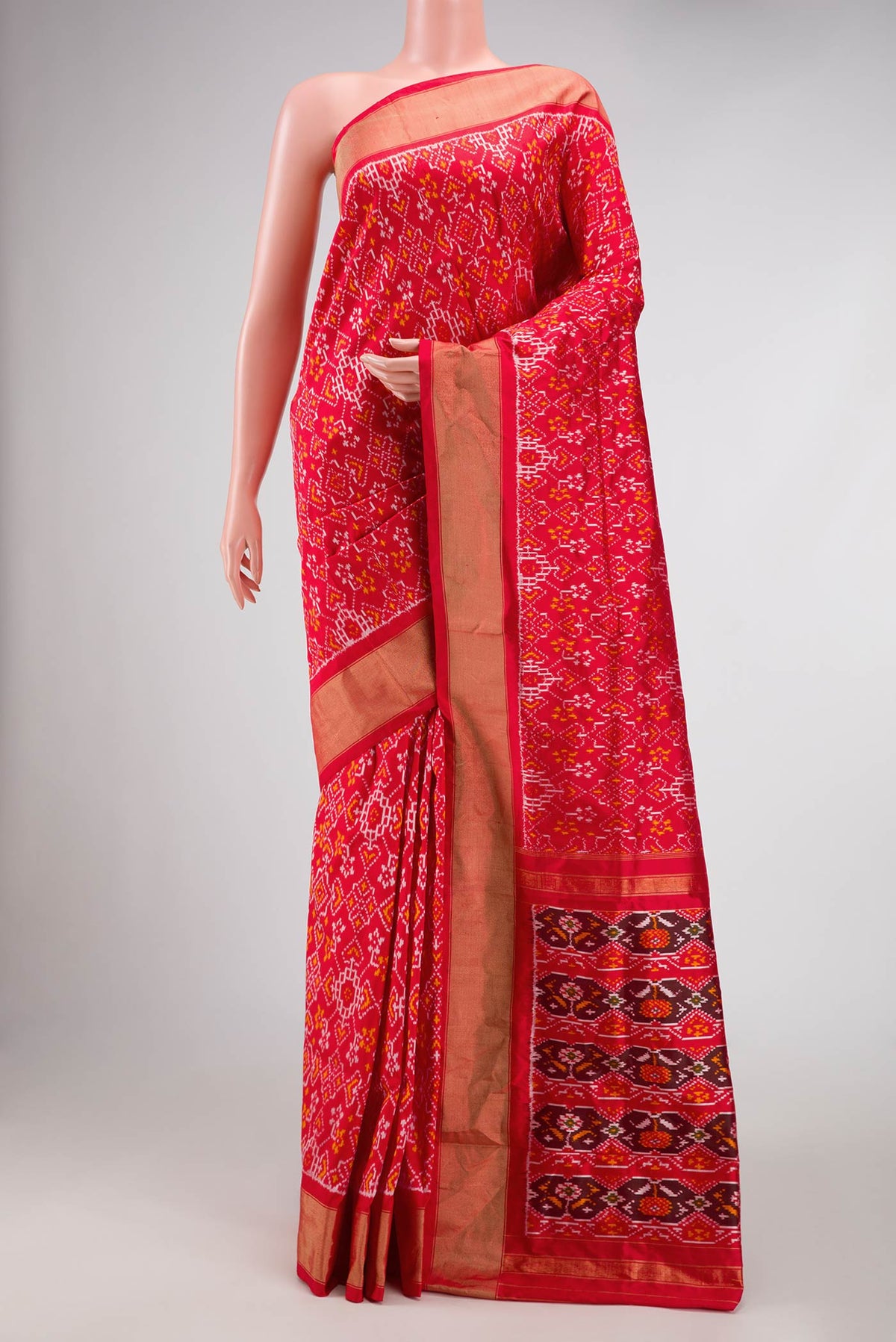 Red Pochampally Silk Saree with Pure Ikat on the body and Zari Border displayed on a mannequin