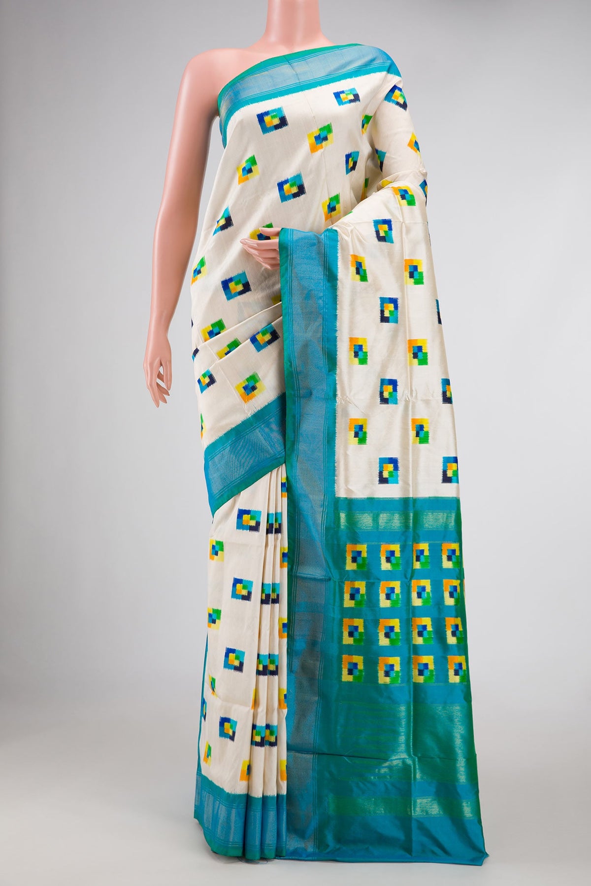 Off White Pochampally Silk Saree with Pure Ikat on the body and Zari Border displayed on a mannequin