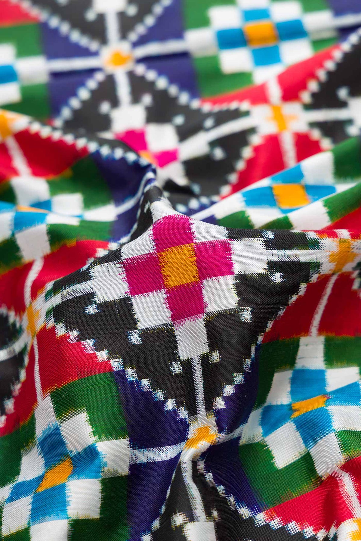 Close up of Multi Color Pochampally Silk Saree with Pure Ikat on the body and Zari Border displaying folds