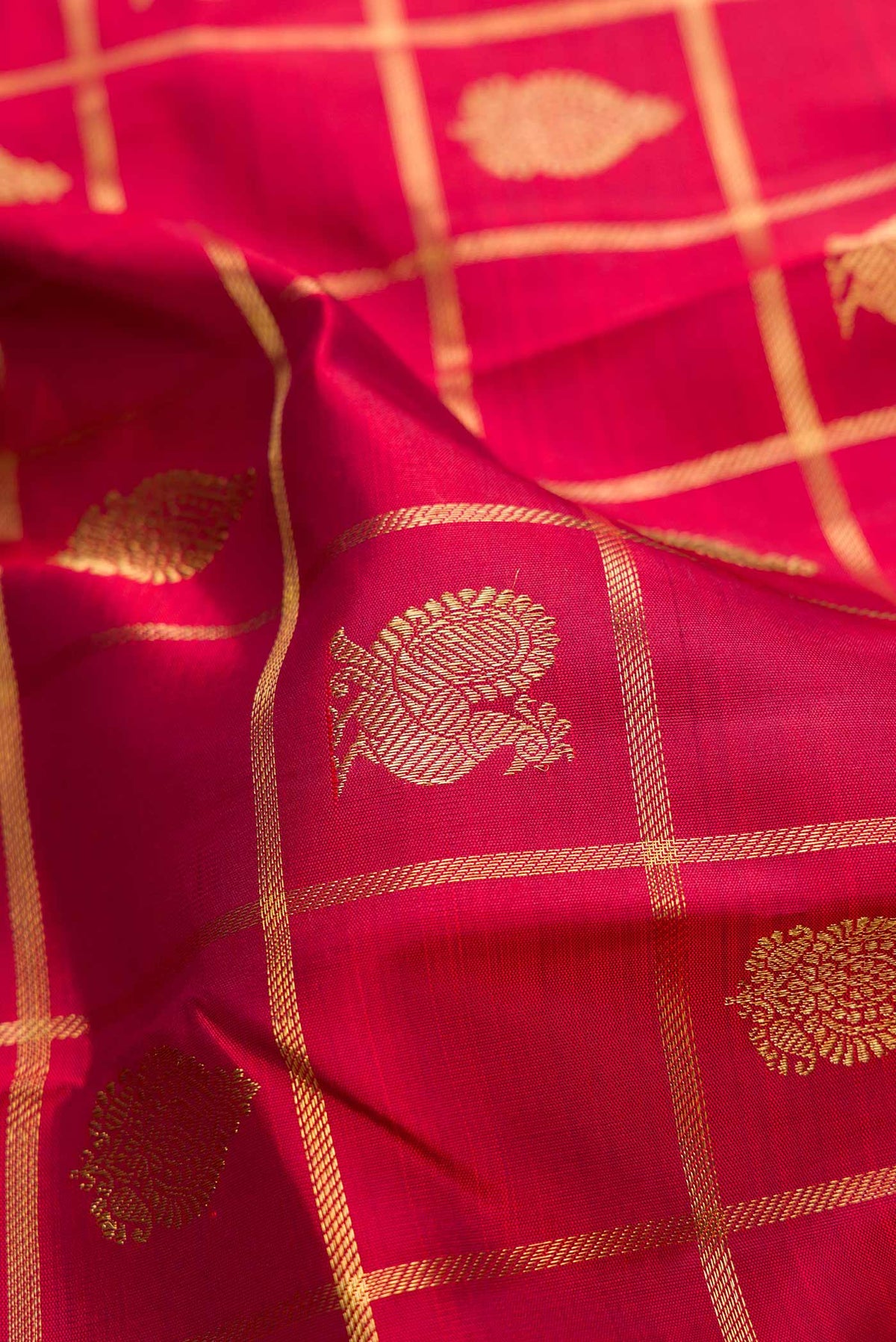 Close up of Pure Silk Pure Zari Maroon Dual Tone Kanjivaram Saree with Checked design on the body and Zari Border.  displaying folds