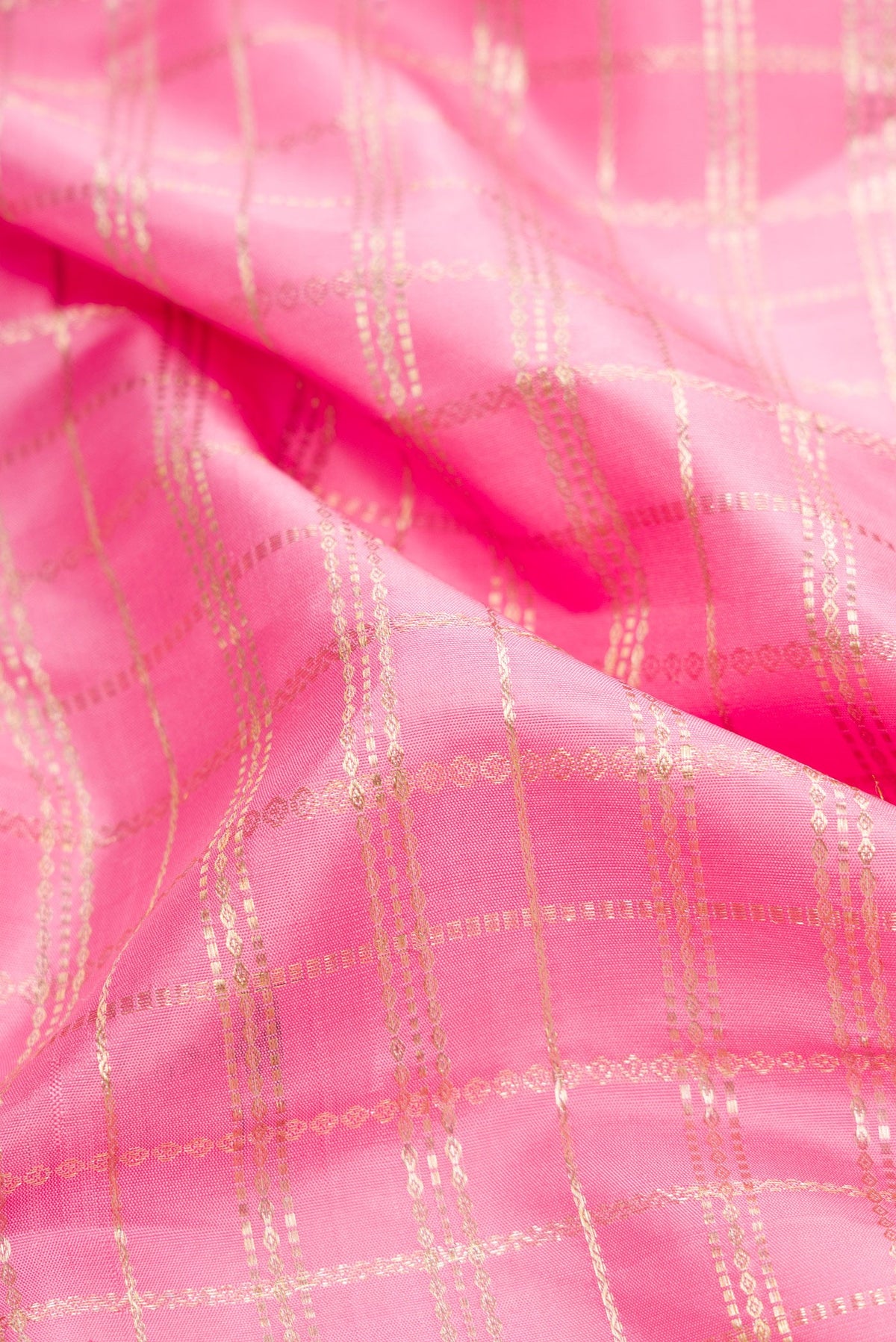 Close up of Pink Dual Tone Kanjivaram Silk Saree with Checked design on the body and Zari Border.  displaying folds