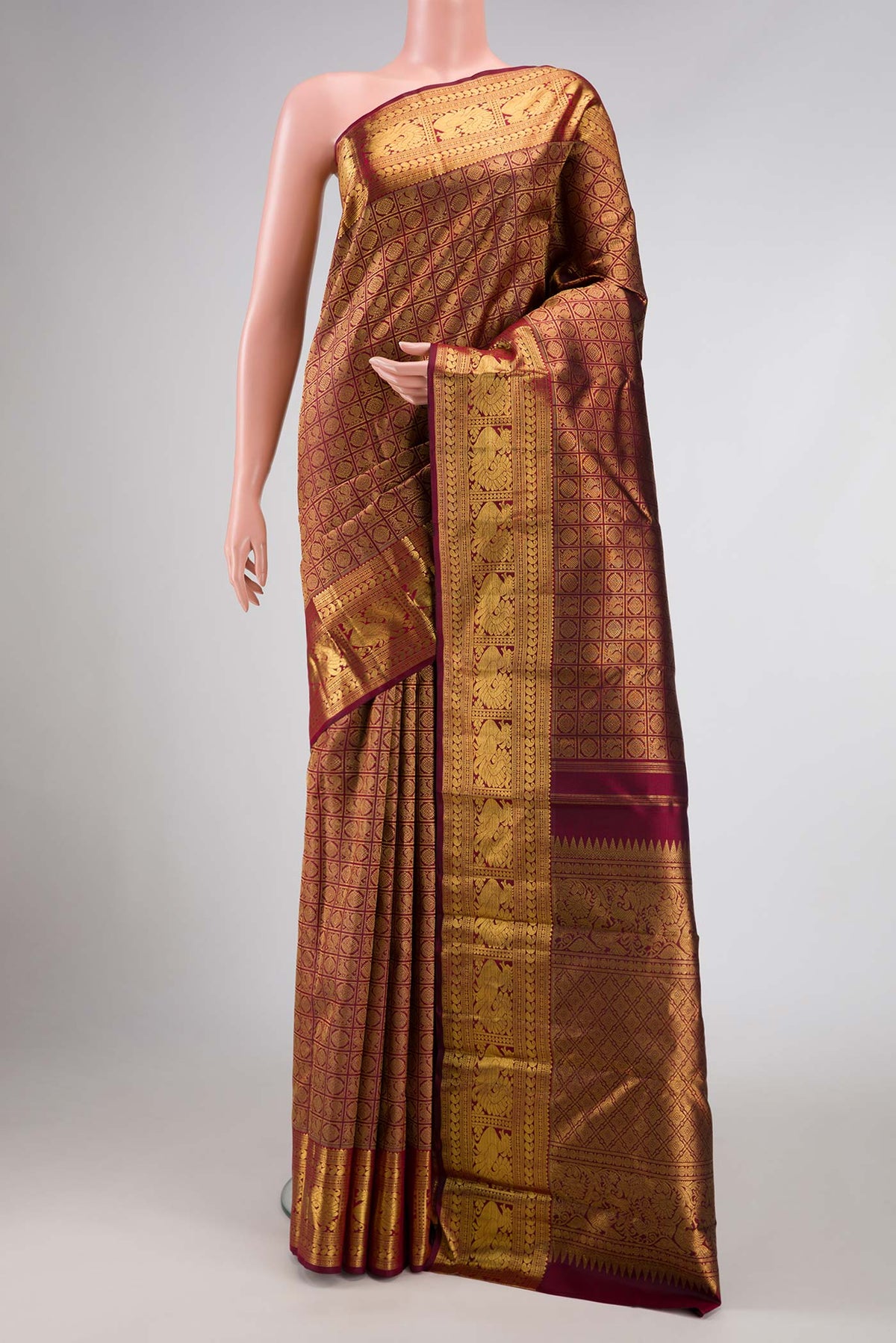 Pure Silk Pure Zari Maroon Dual Tone Kanchipuram Saree with Zari Brocade on the body and Zari Border displayed on a mannequin