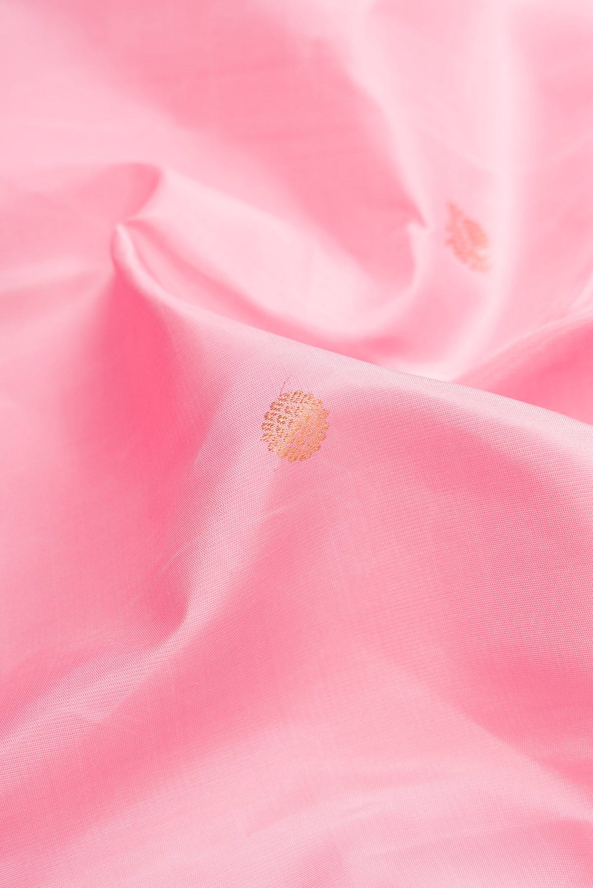 Close up of Pink Dual Tone Kanjivaram Silk Saree with Zari Butta on the body and Zari Border.  displaying folds