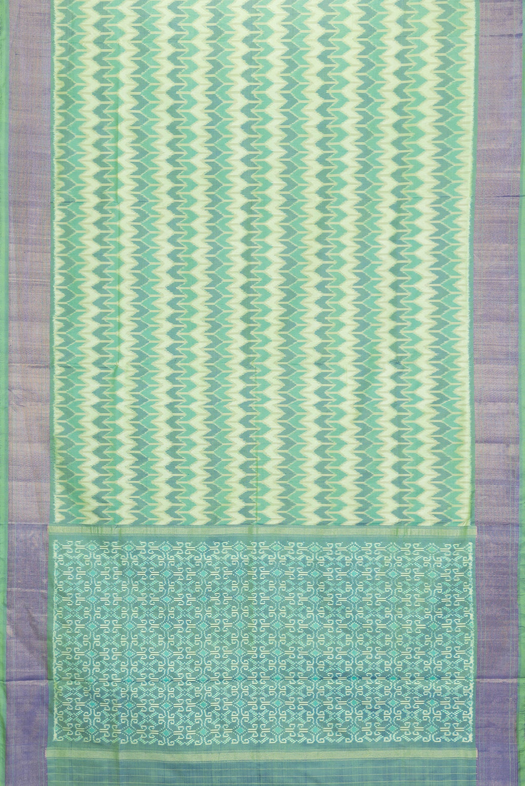 Flat view of Green Dual Tone Double Ikat Saree with Ikat Print on the body and Zari Border. 