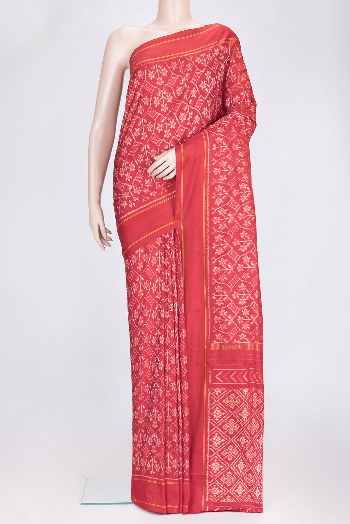 Red Dual Tone Double Ikat Saree with Ikat Print on the body and Plain Border.  displayed on a mannequin