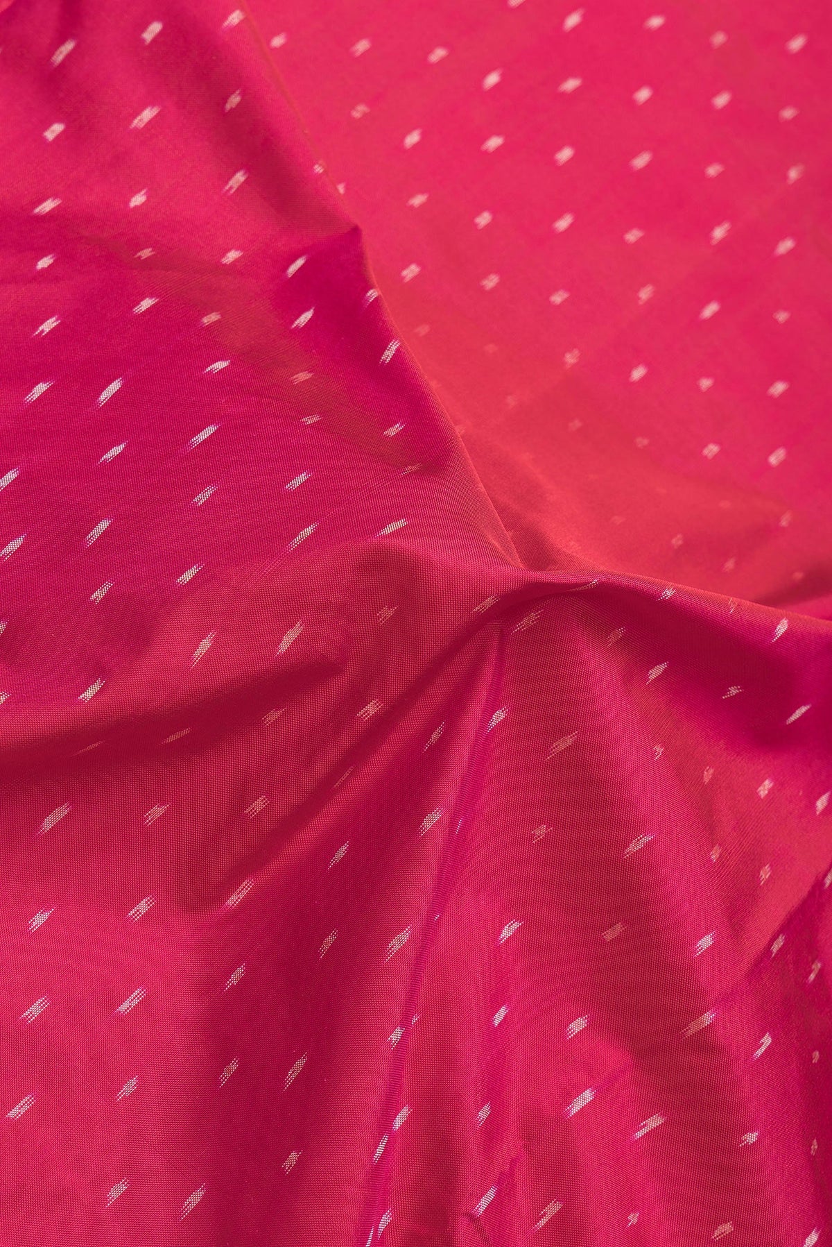 Close up of Maroon Dual Tone Double Ikat Saree with Ikat Print on the body and Plain Border.  displaying folds