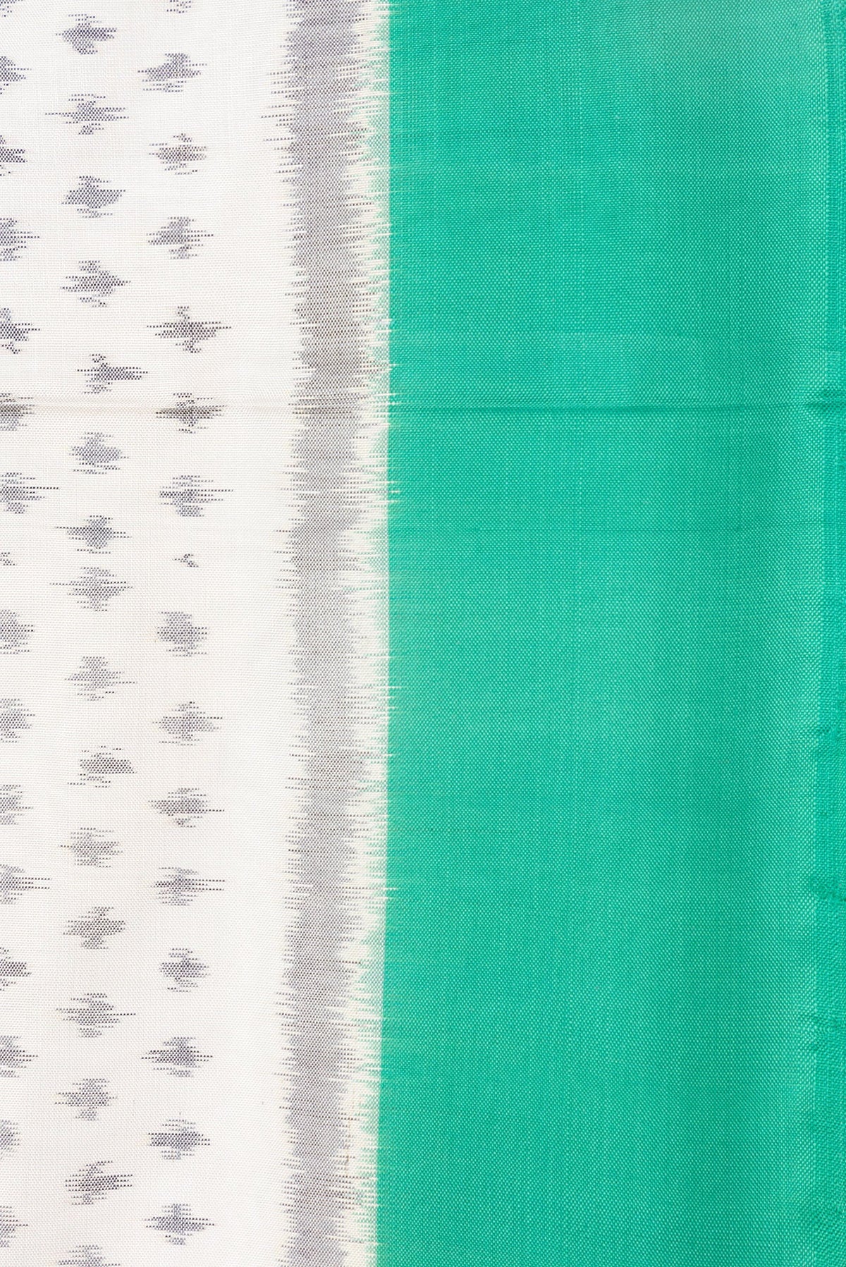 Border image of Off White Dual Tone Double Ikat Saree with Ikat Print on the body and Plain Border. 