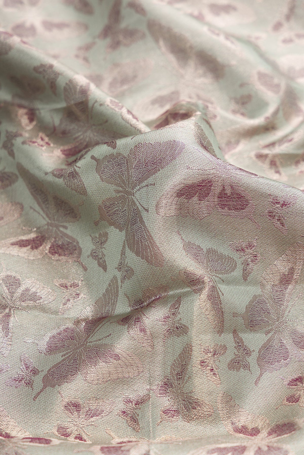 Close up of Light Green Dual Tone Kanjivaram Tissue Silk Saree with Zari Brocade on the body and Fancy Border.  displaying folds