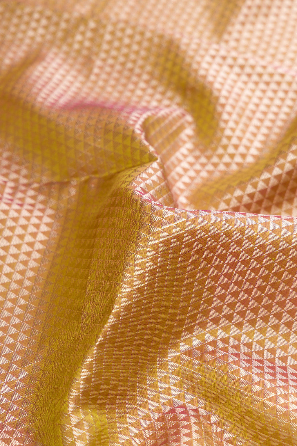 Close up of Gold Dual Tone Kanjivaram Tissue Silk Saree with Zari Brocade on the body and Fancy Border.  displaying folds