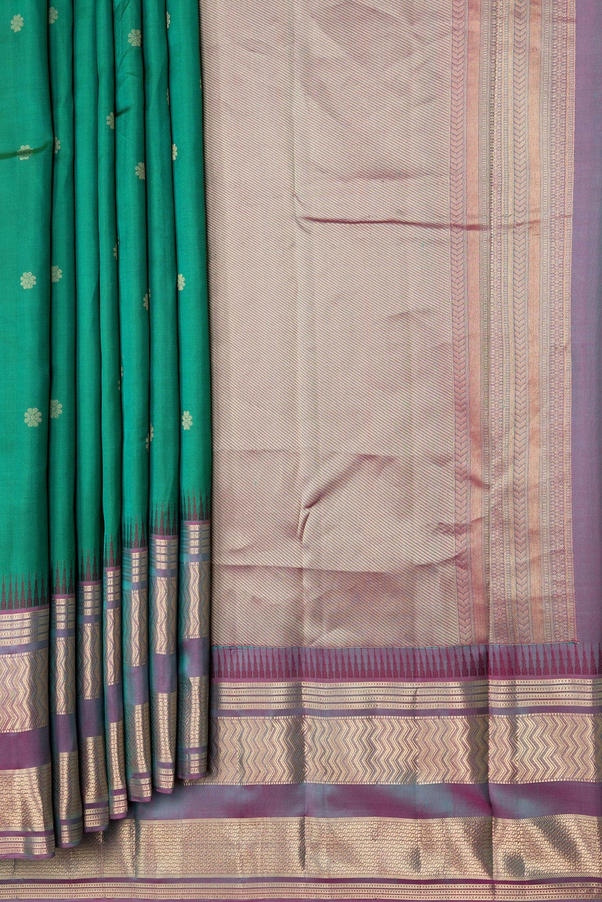 Pleats and pallu of Green Dual Tone Kanjivaram Silk Saree with Zari Butta on the body and Zari Border. 