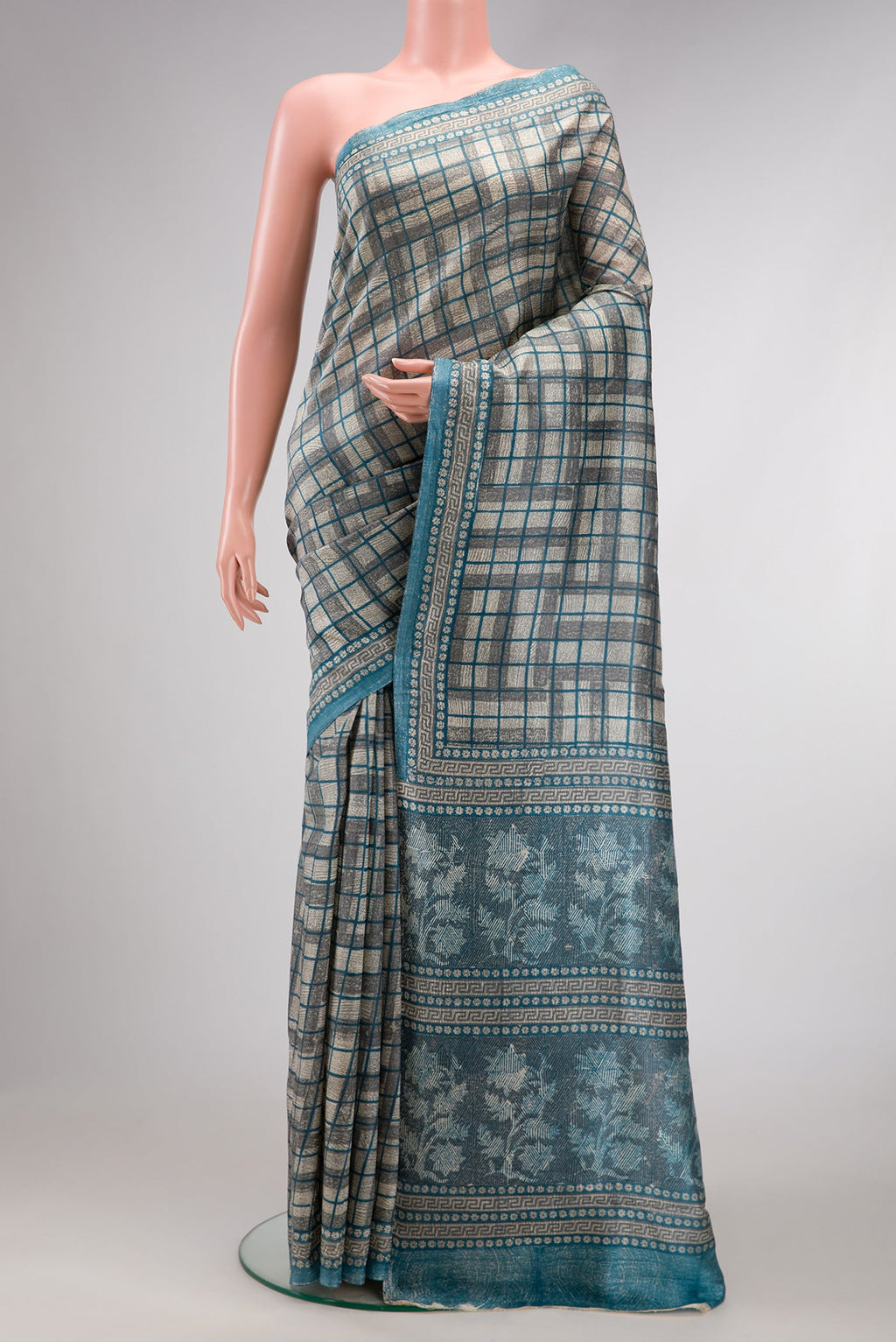 Grey Dual Tone Tussar Silk Saree with Checked design on the body and Fancy Border.  displayed on a mannequin