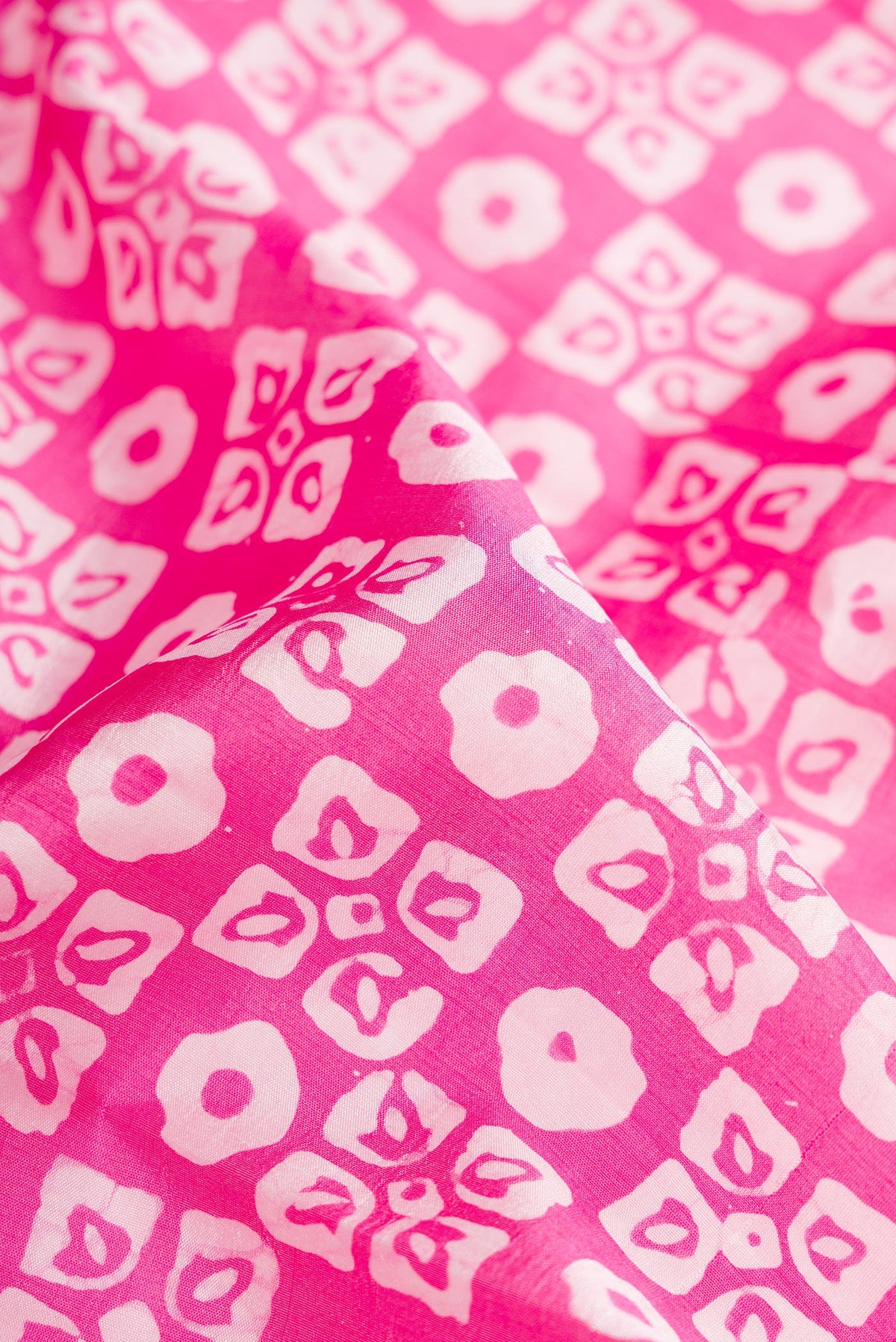 Close up of Pink Dual Tone Tussar Silk Saree with Printed design on the body and Printed Border.  displaying folds
