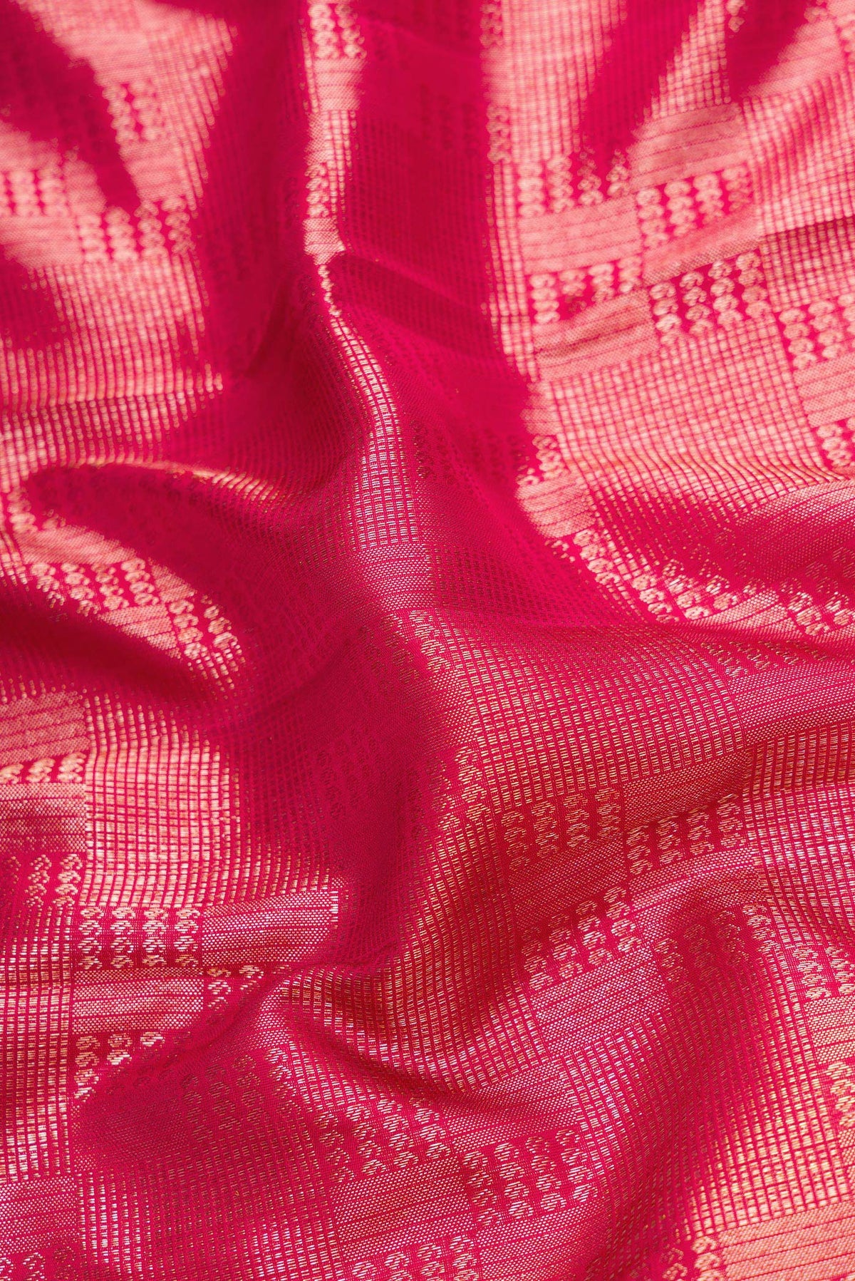 Close up of Maroon Dual Tone Kanchipuram Silk Saree with Zari Brocade on the body and Zari Border.  displaying folds