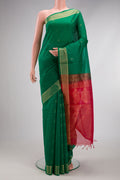 Green Silk Cotton Saree with Zari Butta on the body and Zari Border.  displayed on a mannequin