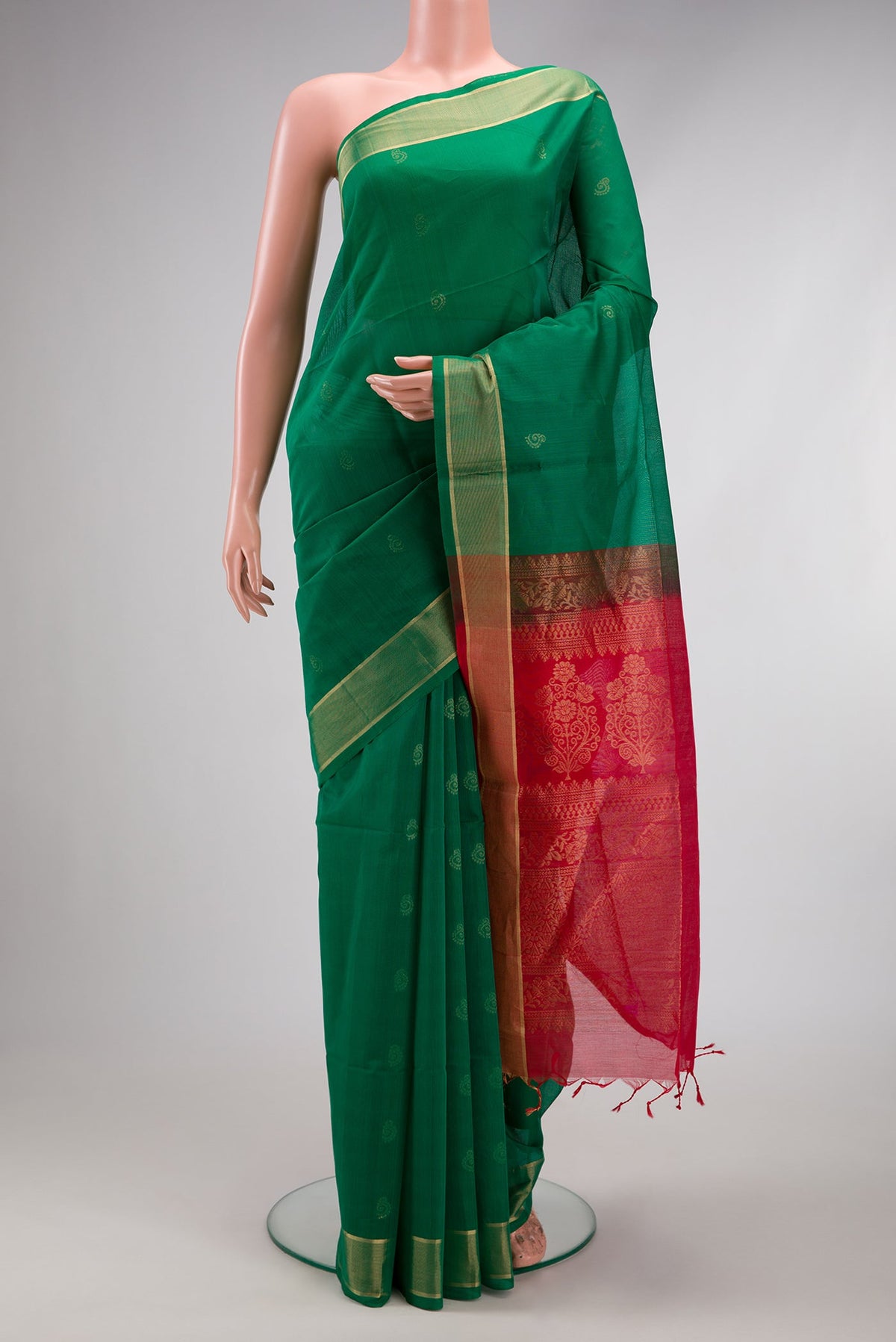 Green Silk Cotton Saree with Zari Butta on the body and Zari Border.  displayed on a mannequin