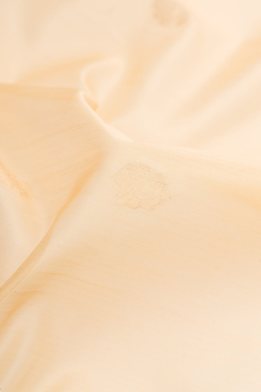 Close up of Sandal Silk Cotton Saree with Zari Butta on the body and Zari Border.  displaying folds