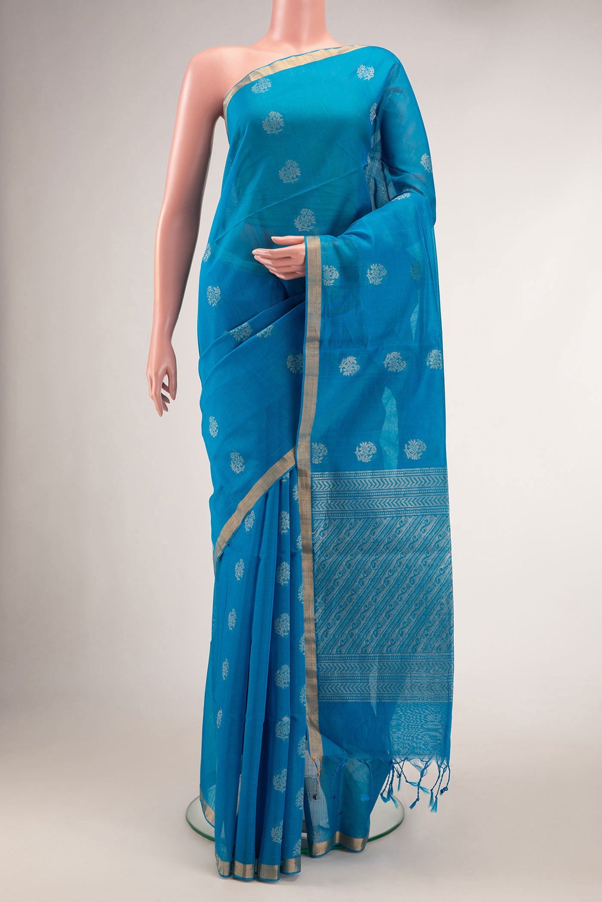 Sky Blue Dual Tone Silk Cotton Saree with Zari Butta on the body and Zari Border.  displayed on a mannequin