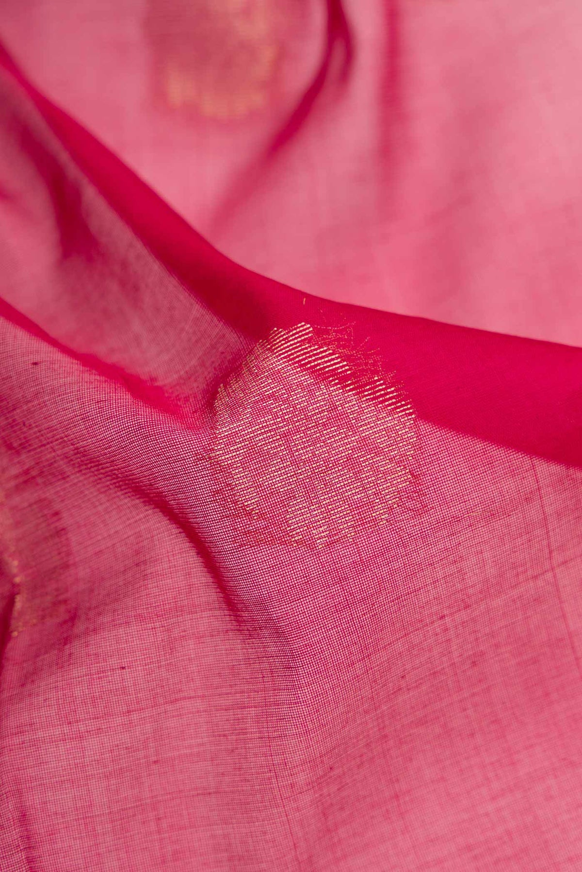 Close up of Maroon Dual Tone Silk Cotton Saree with Zari Butta on the body and Zari Border.  displaying folds