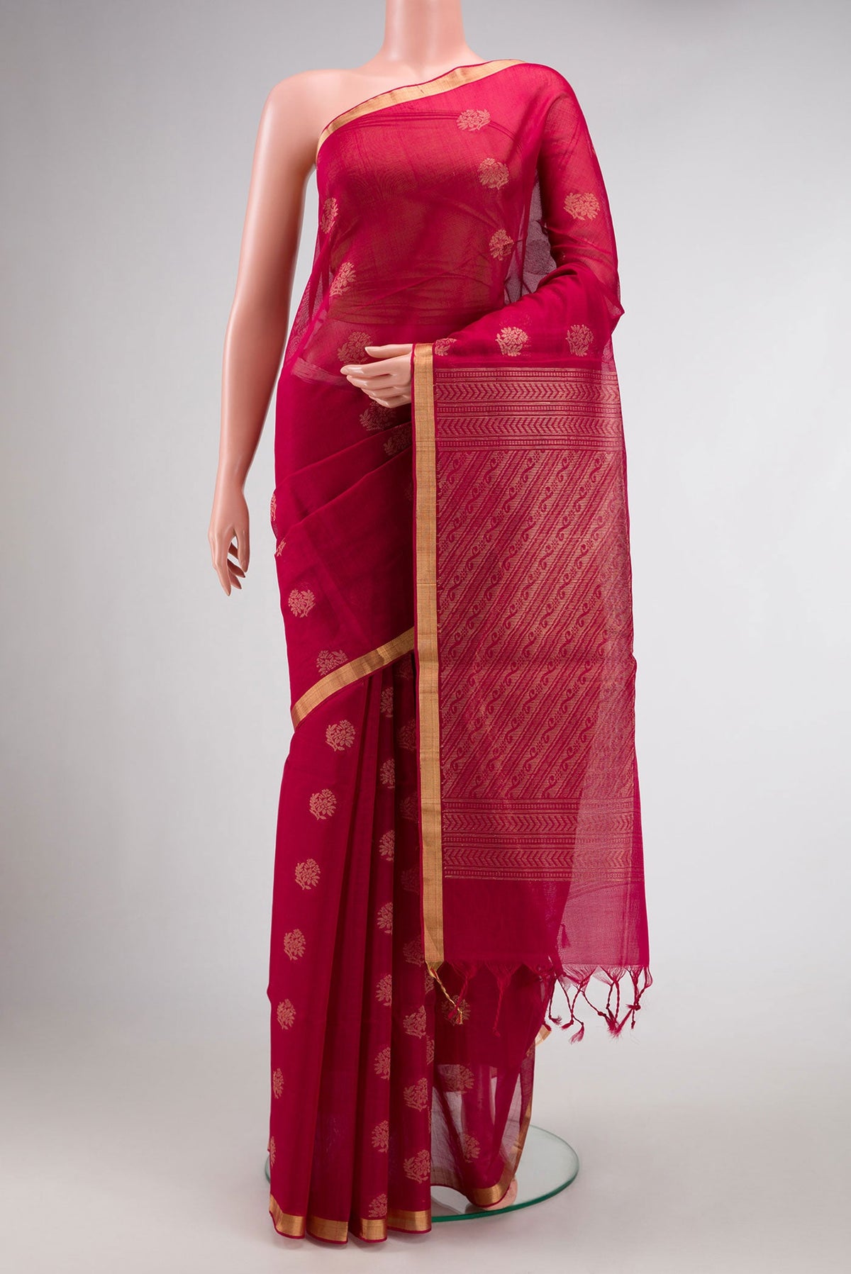 Maroon Dual Tone Silk Cotton Saree with Zari Butta on the body and Zari Border.  displayed on a mannequin