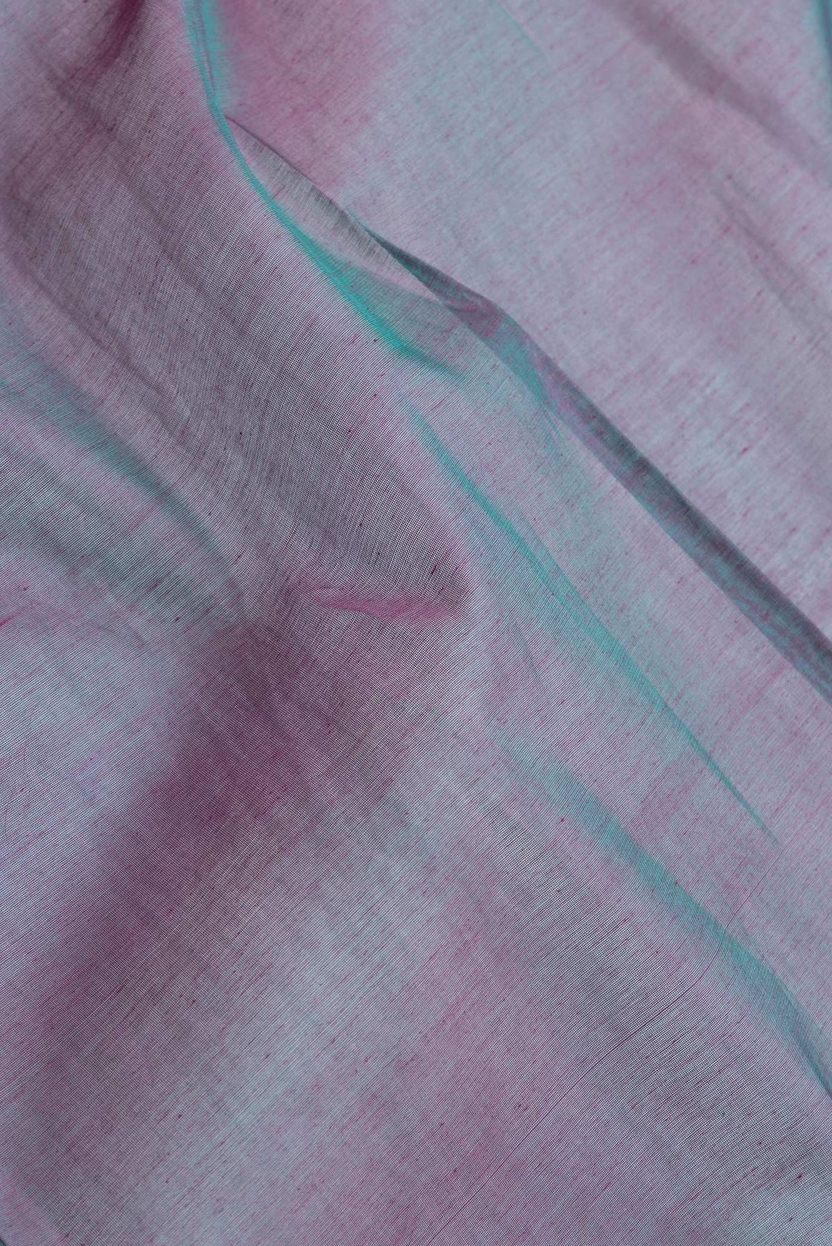 Close up of Peacock Blue Dual Tone Silk Cotton Saree with Zari Butta on the body and Zari Border.  displaying folds