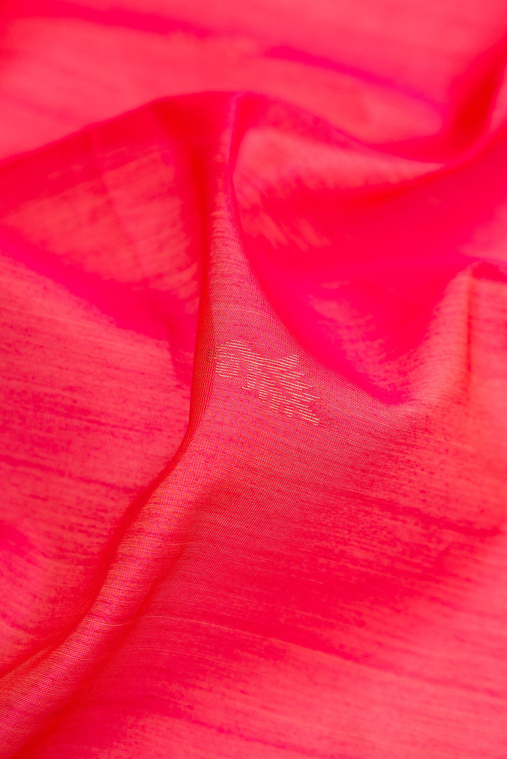 Close up of Pink Silk Cotton Saree with Zari Butta on the body and Zari Border.  displaying folds