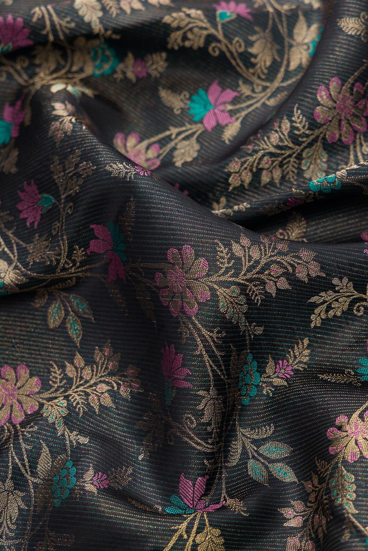 Close up of Black Dual Tone Kanchipuram Silk Saree with Zari Brocade on the body and Fancy Border.  displaying folds