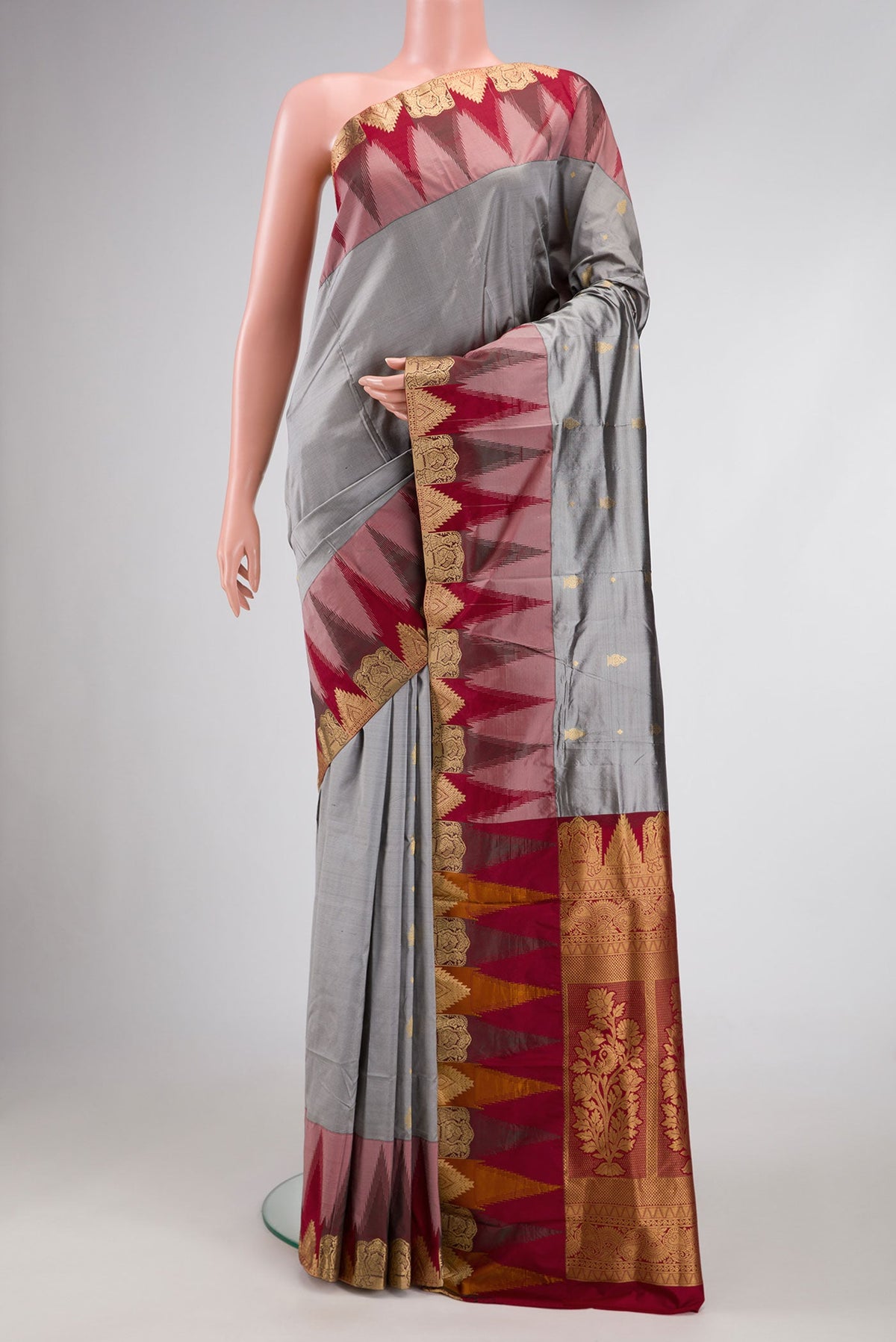 Grey Dual Tone Kanchipuram Silk Saree with Zari Butta on the body and Temple Border.  displayed on a mannequin