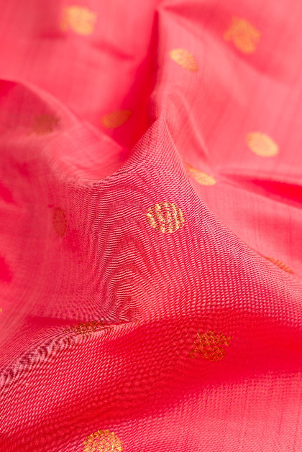 Close up of Pink Kanjivaram Silk Saree with Zari Butta on the body and Zari Border.  displaying folds