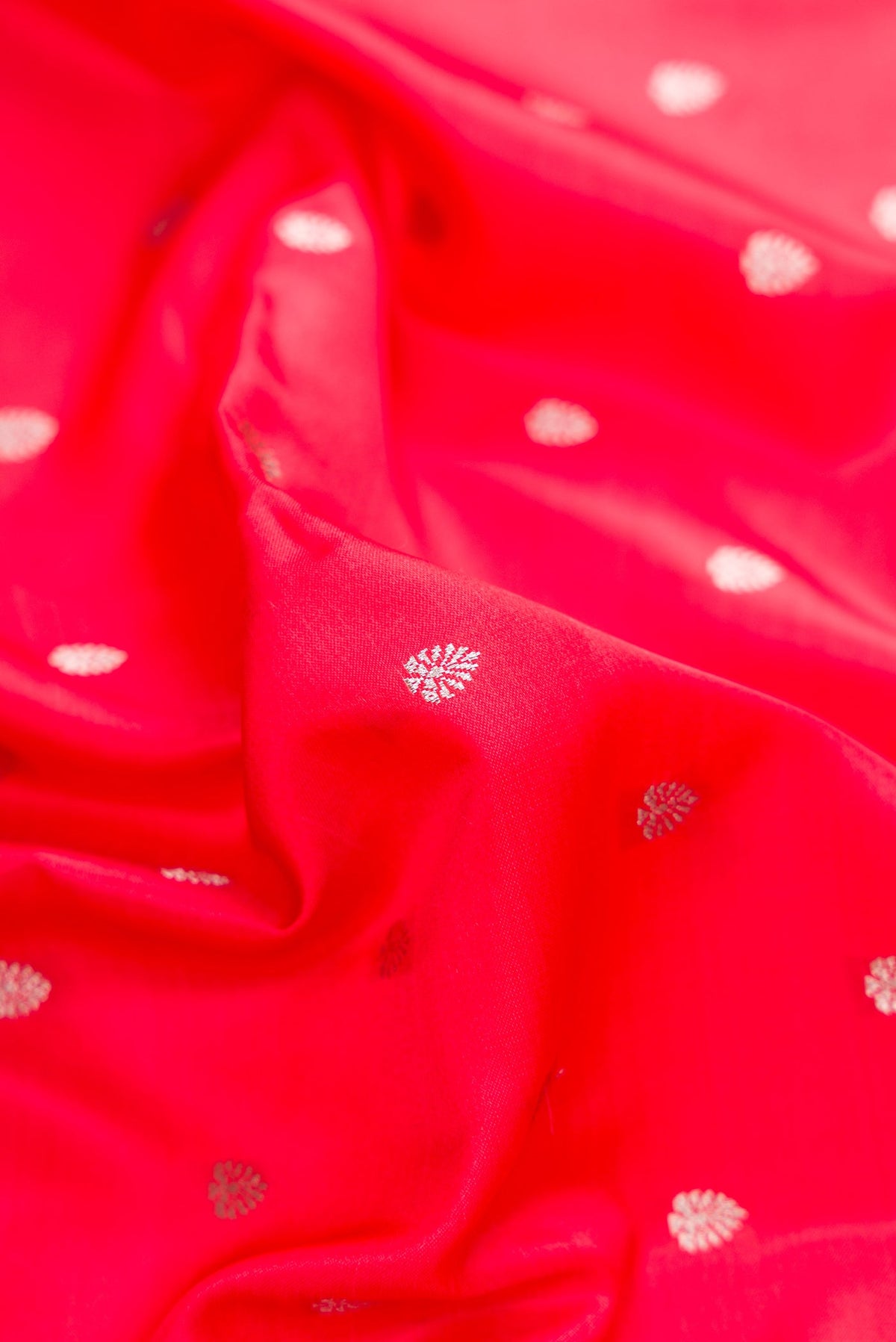 Close up of Dark Pink Dual Tone Banarasi Silk Saree with Zari Butta on the body and Fancy Border.  displaying folds
