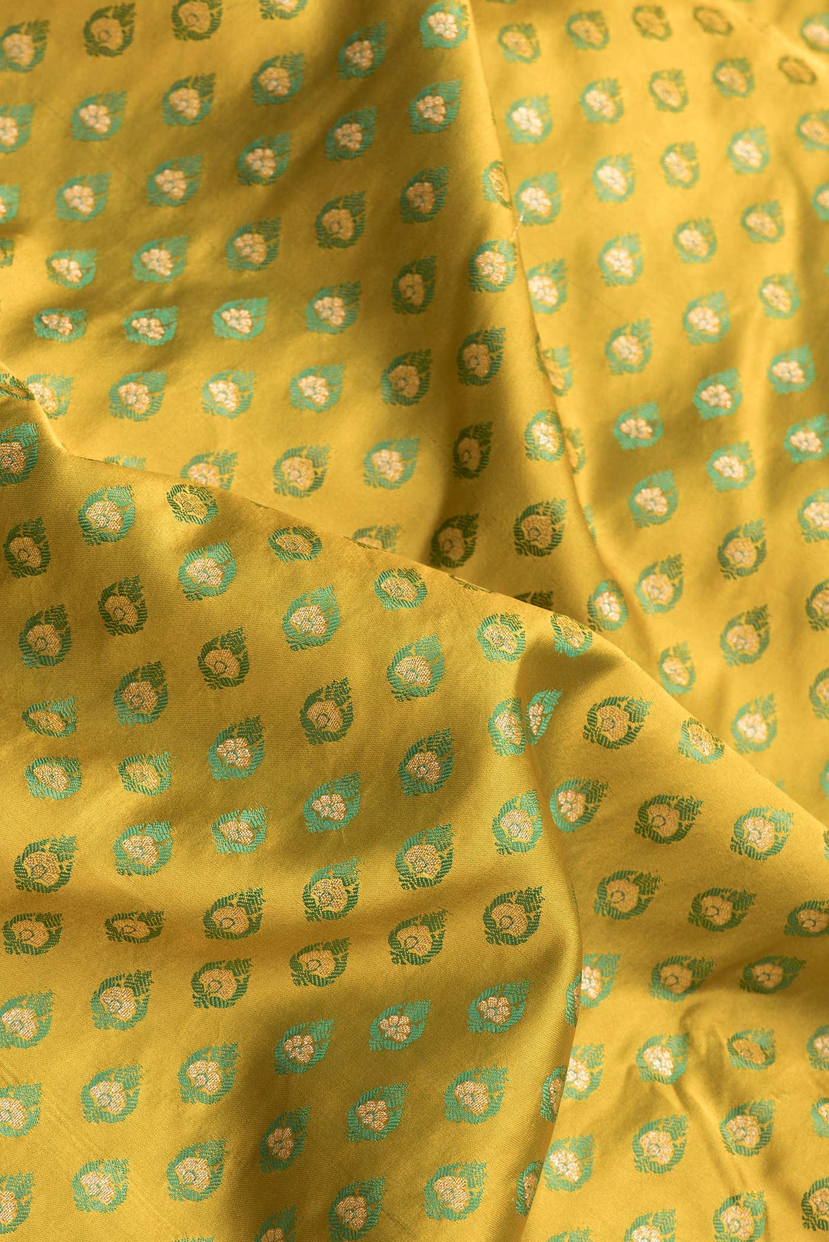 Close up of Mehandi Green Dual Tone Blended Banarasi Silk Saree with Zari And Thread Butta on the body and Zari Border.  displaying folds