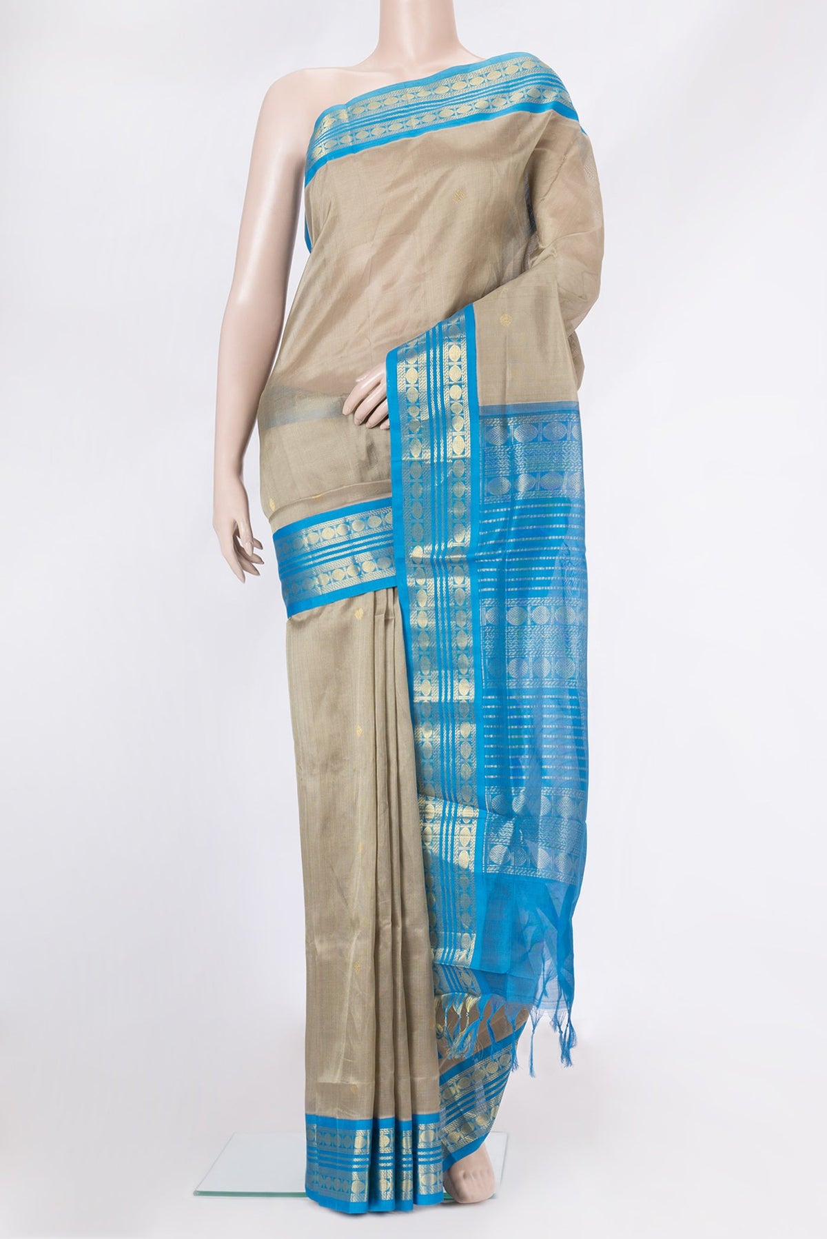 Dark Beige Silk Cotton Saree with Zari Butta on the body and Zari Border.  displayed on a mannequin