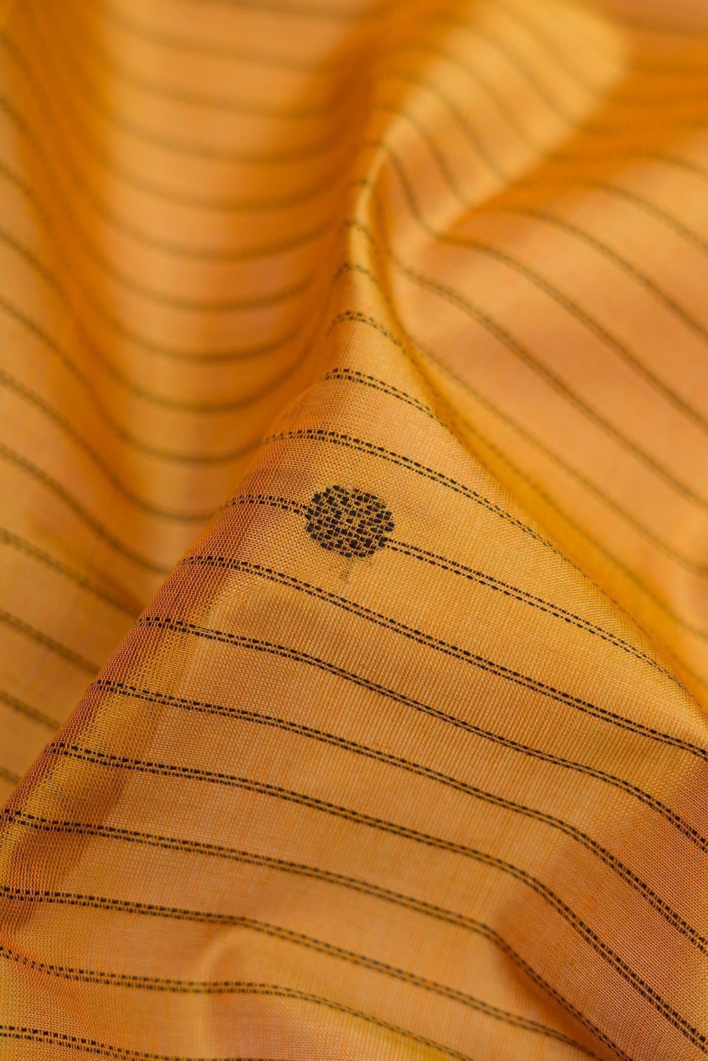 Close up of Mustard Silk Cotton Saree with Stripes on the body and Zari Border.  displaying folds