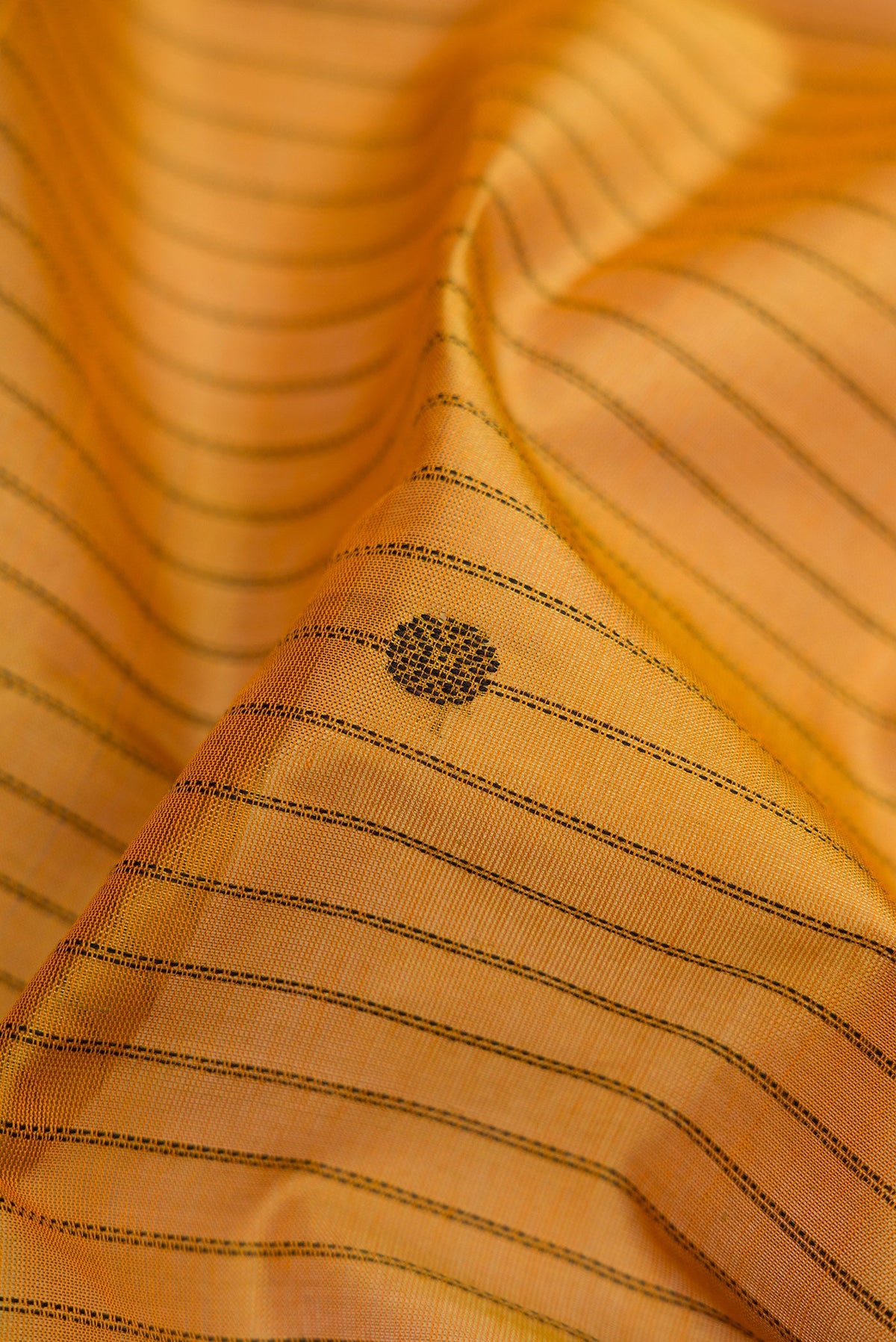 Close up of Mustard Silk Cotton Saree with Stripes on the body and Zari Border.  displaying folds
