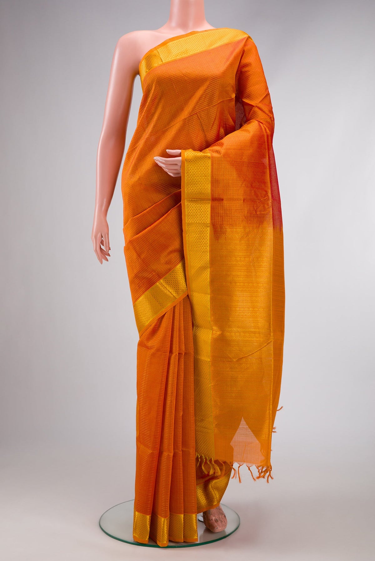 Orange Dual Tone Silk Cotton Saree with Checked design on the body and Zari Border.  displayed on a mannequin