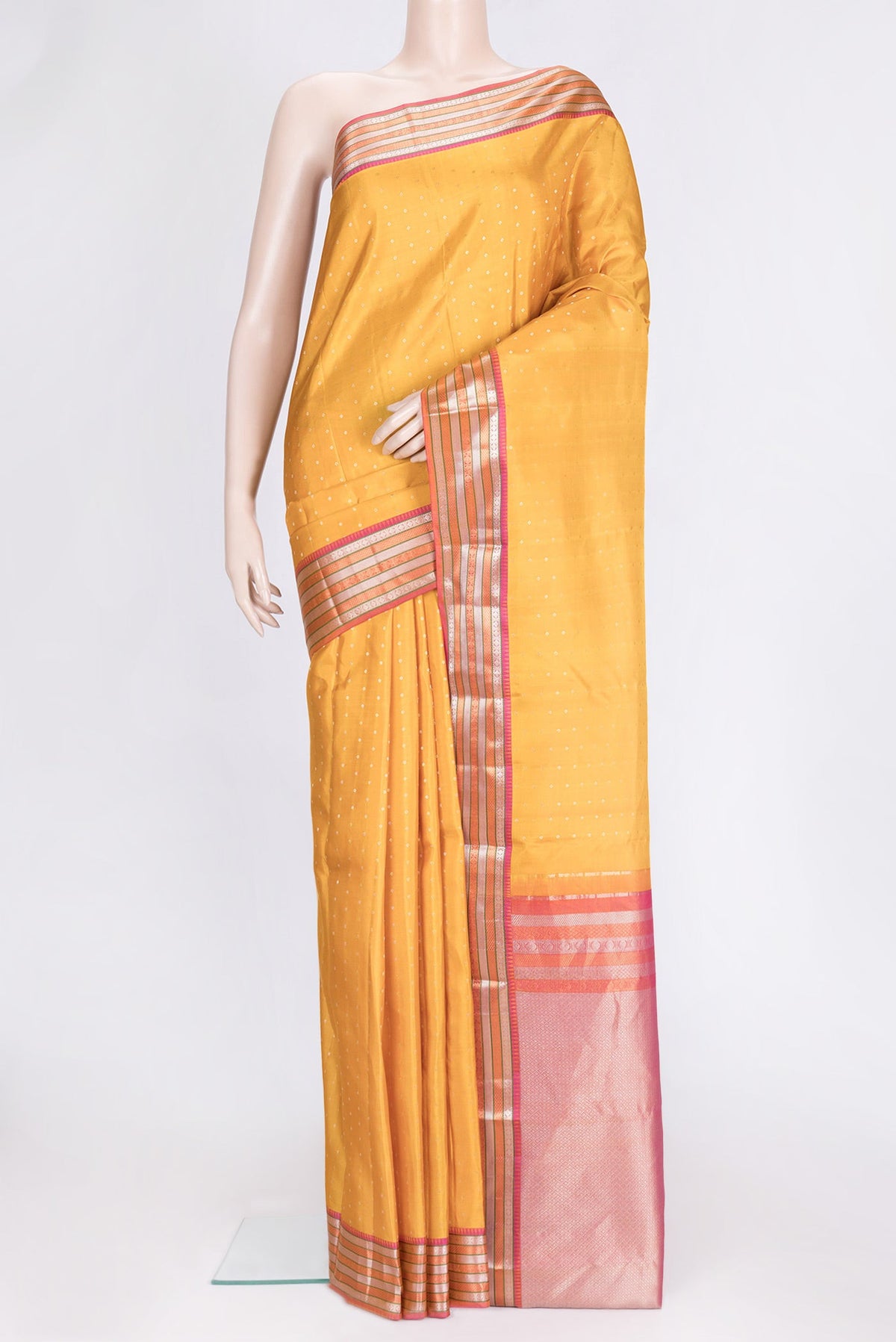 Mustard Dual Tone Kanchipuram Silk Saree with Zari Butta on the body and Zari Border.  displayed on a mannequin