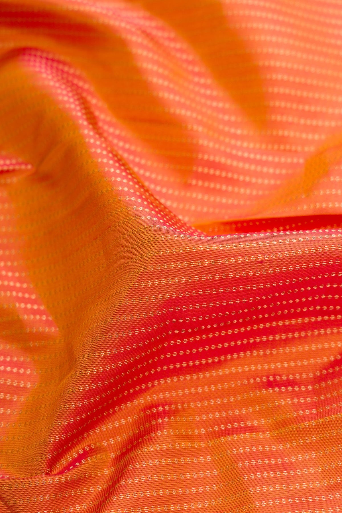 Close up of Mustard Dual Tone Kanchipuram Silk Saree with Stripes on the body and Zari Border.  displaying folds