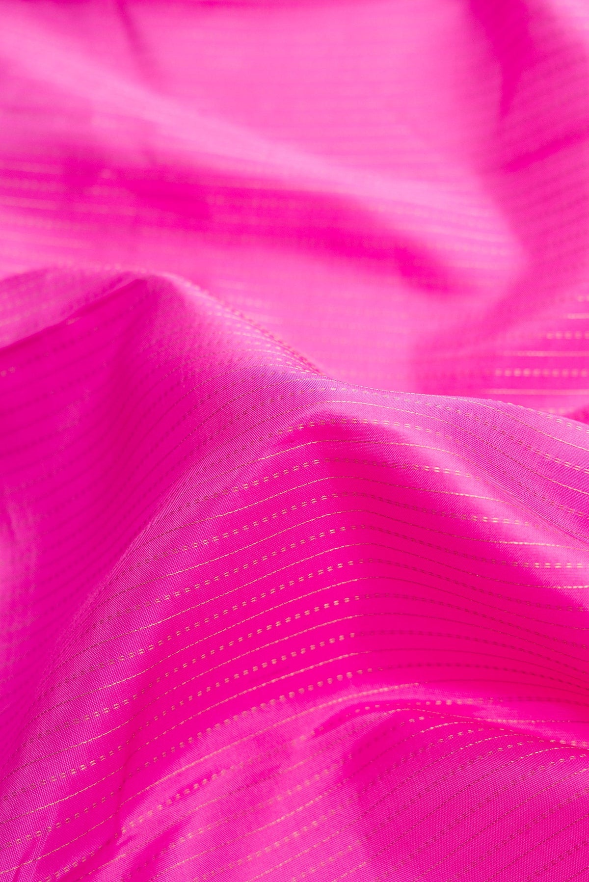 Close up of Pink Dual Tone Kanjivaram Silk Saree with Stripes on the body and Zari Border.  displaying folds