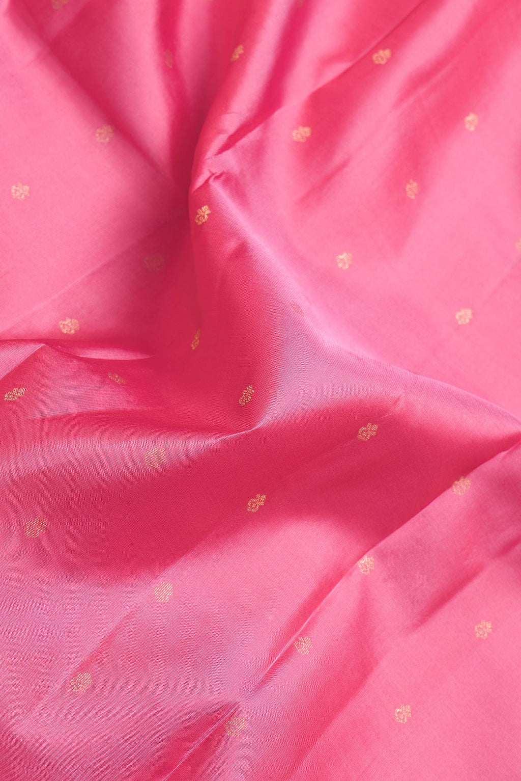Close up of Pink Dual Tone Kanchipuram Silk Saree with Zari Butta on the body and Zari Border.  displaying folds
