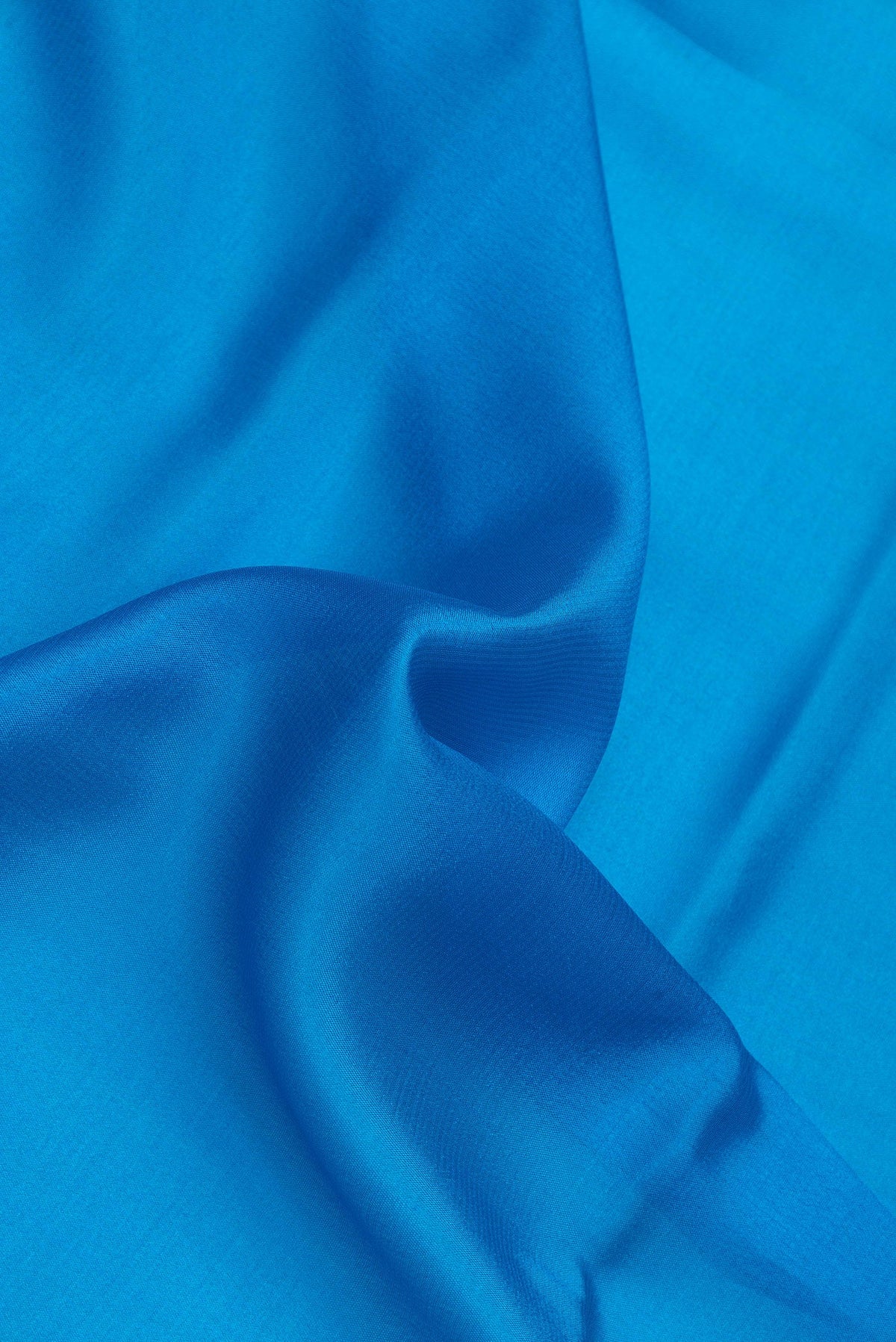 Close up of Royal Blue Dual Tone Mysore Silk Saree with Plain Body and Zari Border.  displaying folds