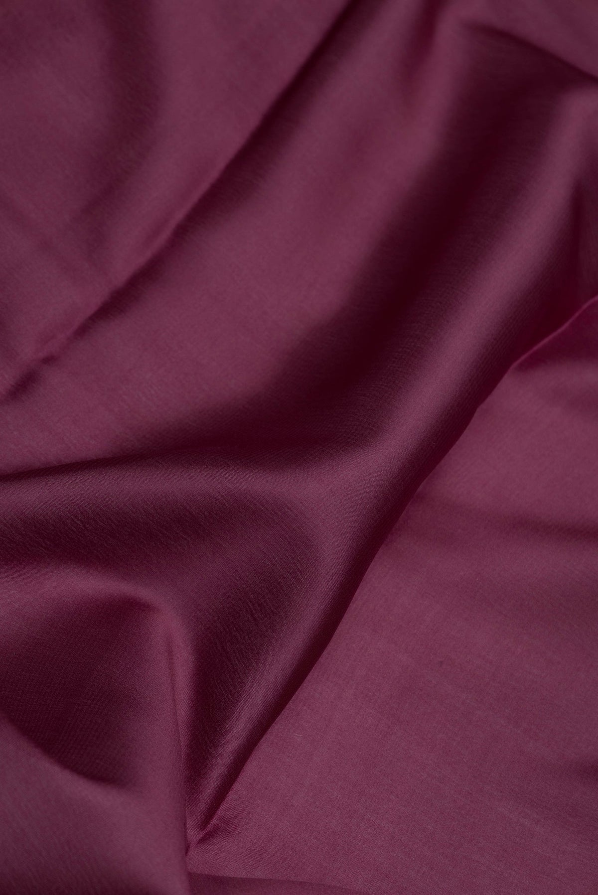 Close up of Burgundy Dual Tone Mysore Silk Saree with Plain Body and Zari Border.  displaying folds