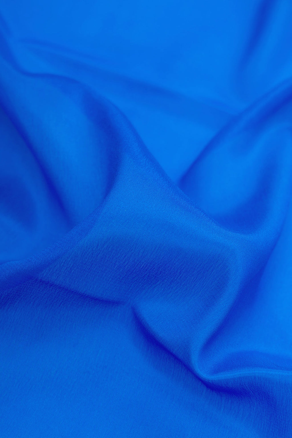 Close up of Royal Blue Dual Tone Mysore Silk Saree with Plain Body and Zari Border.  displaying folds