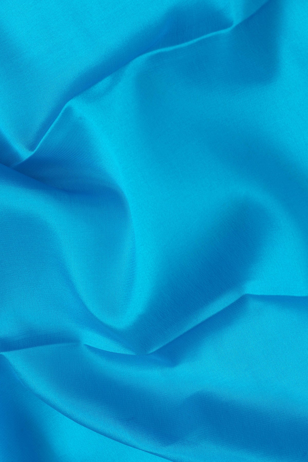 Close up of Sky Blue Dual Tone Mysore Silk Saree with Plain Body and Zari Border.  displaying folds