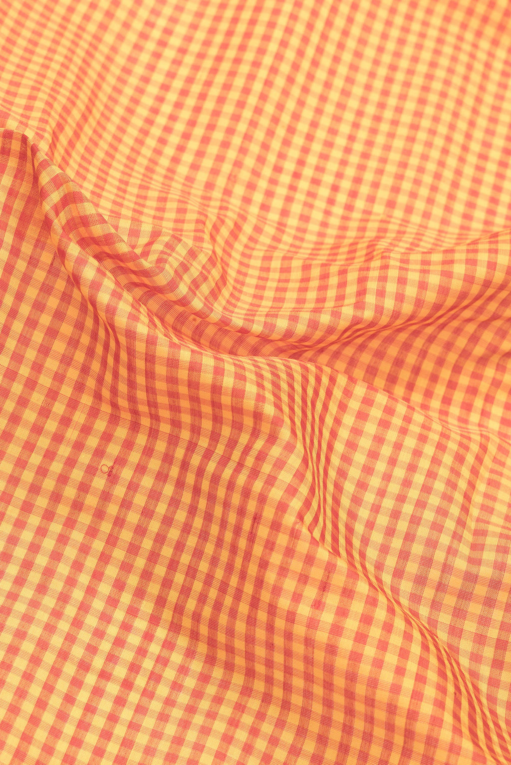 Close up of Orange Dual Tone Gadwal Silk Saree with Checked design on the body and Zari Border.  displaying folds