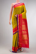 Mehandi Green Dual Tone Gadwal Silk Saree with Zari Butta on the body and Zari Border.  displayed on a mannequin